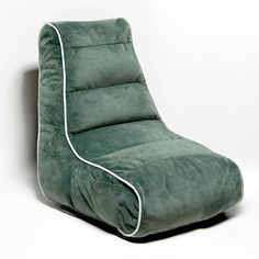 a large green chair sitting on top of a white floor