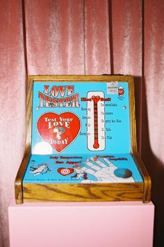 an old fashioned game machine with the words love theater on it's back side