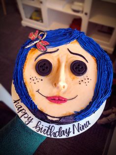 a birthday cake that has been decorated to look like a girl with blue hair and eyes