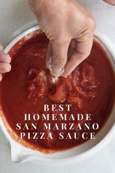 a person dipping sauce into a bowl with pizza sauce in it and the words best homemade san maraano pizza sauce