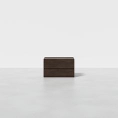 a wooden box sitting on top of a white floor