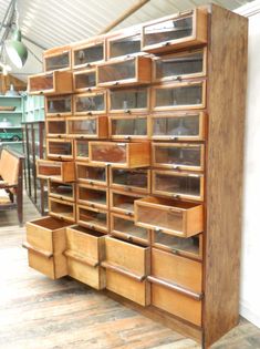 a large wooden shelf with many drawers on it