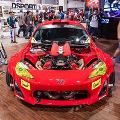 a red sports car with its hood open