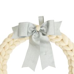 a white rope wreath with a bow on top