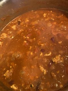 a large pot filled with stew sitting on top of a stove