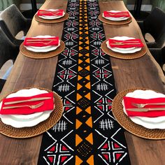 a long table set with place settings and plates