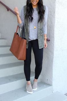 Leggings And Sneakers Work Outfit, Legging And Vest Outfits, Olive Green Leggings Outfit Casual, Professional Outfits With Leggings, Leggings And Tennis Shoes Outfit, Black Jegging Outfits, Vest Work Outfit, Black Jeggings Outfit, Casual Black Leggings Outfit