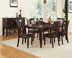 a dining room table and chairs with brown leather upholstered seats in front of a window