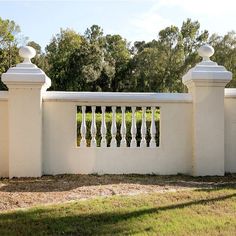 a white fence with wrought iron balconies