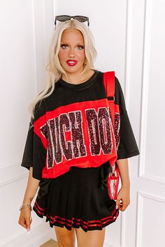 - Show off your team spirit in this dazzling oversized 'TOUCHDOWN' tee! Featuring a sequined design and chic unfinished seam accents, you'll shine on game day. Get the Game Day essentials for the Arkansas Razorbacks, Arkansas State Red Wolves, Texas A&M Aggies, Texas Tech Red Raiders, or the University of Georgia Bulldogs teams. - Unlined lightweight material with unfinished seam accents - A sequined 'TOUCHDOWN' design across the front - Short drop sleeves - An oversized silhouette that ends in Trendy Black T-shirt With Glitter Print, Casual Black Tops With Glitter Print, Casual Black Sequined T-shirt, Black School Spirit T-shirt With Slogan, Black Cotton T-shirt With Glitter Print, Black Cotton Top With Glitter Print, Black T-shirt For Fall Game Day, Black T-shirt For Game Day In Fall, Casual Tops With Glitter Print For Streetwear