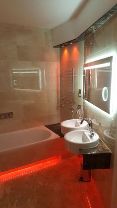 a bathroom with two sinks and a bathtub