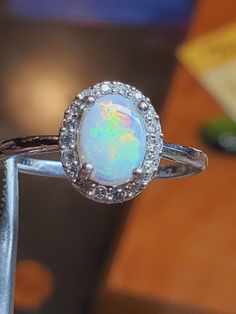 Very pretty little 5x7mm white Australian opal surrounded by cubic zirconia on a slender shiny silver band, light and simple and beautiful Engagement Ring Opal, Opal Promise Ring, Opal Engagement Ring, Ring Opal, Opal Engagement, Engagement Rings Opal, Opal Ring, Australian Opal, Shiny Silver