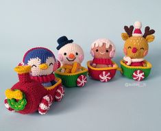 four crocheted christmas toys sitting on top of each other