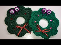 two green crocheted wreaths with googly eyes