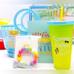 plastic cups are lined up on the table with balloons and other items around them that say summer catching must be fun