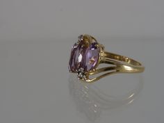 This beautiful vintage 1990's 3 stone ring is constructed of solid 14k yellow gold. The 3 natural Amethysts are cut into large Marquise and accented with 6 natural Diamonds. This ring ships in a brand new ring box. RING SIZE: 7.25 US (Sizable by your local jeweler) Metal: 14k yellow gold (Stamped 14K and verified by acid test) Gemstones: 3 Marquise Cut Amethyst aprx 10mm x 5mm and 6 Small Round Cut Accent Diamonds 1.5mm Weight: 3.9 grams MEASUREMENTS: from north to south: 14.5mm shank: 1.5mm sit Oval Three Stone Amethyst Ring, Fine Jewelry, Gold Three-stone Amethyst Ring For Anniversary, Classic Three Stone Amethyst Ring For Formal Occasions, Yellow Gold Three Stone Amethyst Ring, Three Stone Amethyst Ring In Yellow Gold, Anniversary Yellow Gold Three-stone Amethyst Ring, Formal Oval Three-stone Amethyst Ring, Gig Harbor Wa, 3 Stone Ring