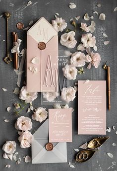 the wedding stationery was done in pink and gray, with white flowers on top