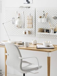 a desk with a chair and some cups on it