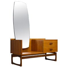 a large mirror sitting on top of a dresser next to a wooden drawer with drawers