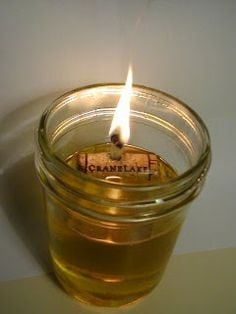 a lit candle in a jar filled with liquid