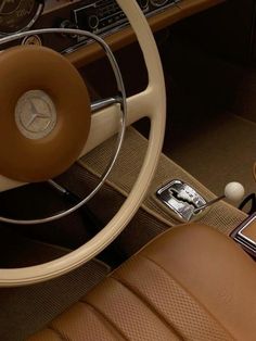 the interior of a car with steering wheel, dash board and dashboard controls on display