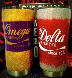 two sodas with glitter on them sitting next to each other