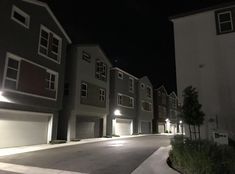 a row of townhouses lit up at night