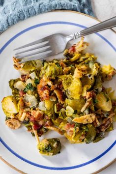 a white plate topped with brussel sprouts and bacon