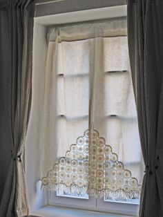 the curtains are hanging in front of the window