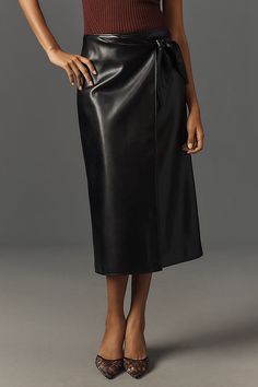 The PAIGE Odgen Skirt is crafted from soft stretch faux leather and features a fully functional wrap silhouette, draped details, and a tie at the side. | Ogden Faux-Leather Midi Skirt by PAIGE in Black, Women's, Size: 8, Leather/Polyurethane at Anthropologie Faux Leather Midi Skirt, Leather Midi Skirt, Timeless Wardrobe Staples, Black Midi Skirt, 50 Fashion, Guest Dresses, Lifestyle Brands, Wardrobe Staples, Midi Skirt