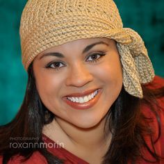 a smiling woman wearing a knitted hat