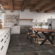 a large kitchen with white cabinets and wooden ceiling beams, along with a dining table surrounded by chairs