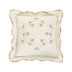 a white pillow with pink flowers on the front and back of it, sitting on a white surface