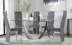 a glass table with white chairs around it