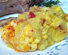 an omelet is on a plate next to some meat