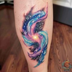 a colorful tattoo on the leg of a woman with stars and swirls in it