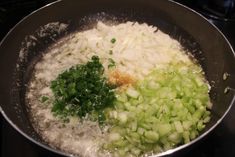 onions, celery and seasoning in a pan on the stove top with water