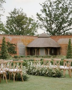 an outdoor ceremony setup with chairs and flowers