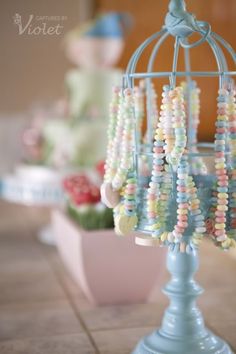 a birdcage filled with beads on top of a table