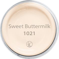 a jar of sweet buttermilk sitting on top of a white tablecloth with the words,'sweet buttermilk 1011 '