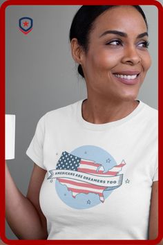 This pin is an image of a woman wearing Patriot Depot's "Americans are dreamers too" t-shirt while drinking coffee. The shirt is a light blue circle with stars. Over the circle is an outline of the mainland United States with the USA flag within the outline. Across the design is a benner that says "Americans are dreamers too". Mens Patriotic Shirts, Patriotic Accessories, Patriotic Hats, 4th Of July Outfit, Patriotic Outfit, 4th Of July Outfits, Patriotic Shirts