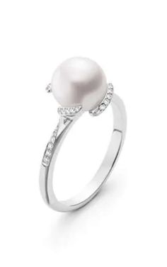 a white pearl and diamond ring with diamonds on the sides, set in 18k white gold