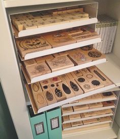 several wooden boxes are stacked on top of each other in a bookcase with drawers