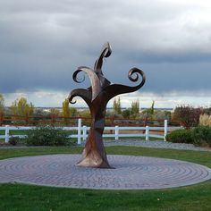 a sculpture in the middle of a grassy area