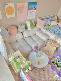 a living room filled with lots of furniture and flowers in vases on the coffee table