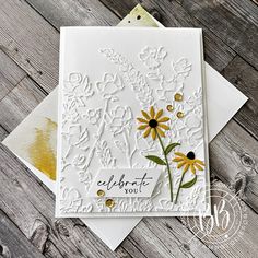 a white card with yellow flowers on it