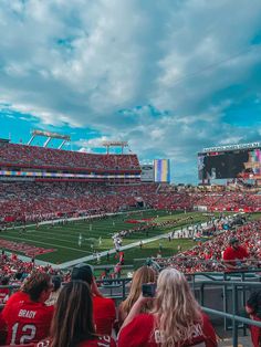 a football stadium filled with people watching the game