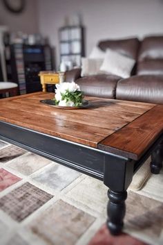 a coffee table with flowers on it in a living room