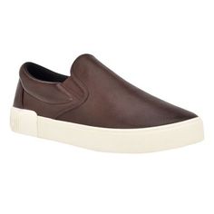 Essential and on trend, this slip-on sneaker will easily complete any look. It features a round shaped toe, a slight platform and Calvin Klein logo patch on the back counter. Founded in New York in 1968, the brand elevates everyday essentials to globally iconic status. | Calvin Klein Men's Rydor Slip-on Casual Sneakers, Brown, 10M Slip-on Sneakers With Gum Sole, Slip-on Slip-resistant Streetwear Sneakers, Slip-on Slip-resistant Sneakers For Streetwear, Brown Perforated Low-top Slip-ons, Brown Slip-on Sneakers With Contrast Sole, Synthetic Slip-ons For Streetwear, Synthetic Slip-ons With White Sole For Streetwear, Textured Sole Synthetic Slip-ons For Streetwear, Modern Slip-ons For Streetwear