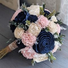 a bridal bouquet with blue, pink and white flowers